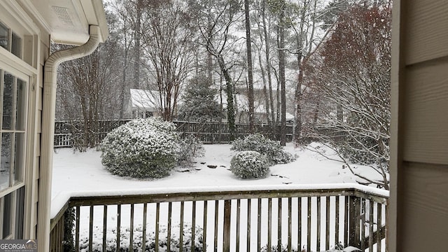 yard covered in snow with fence