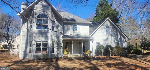 view of front of property featuring fence and a chimney