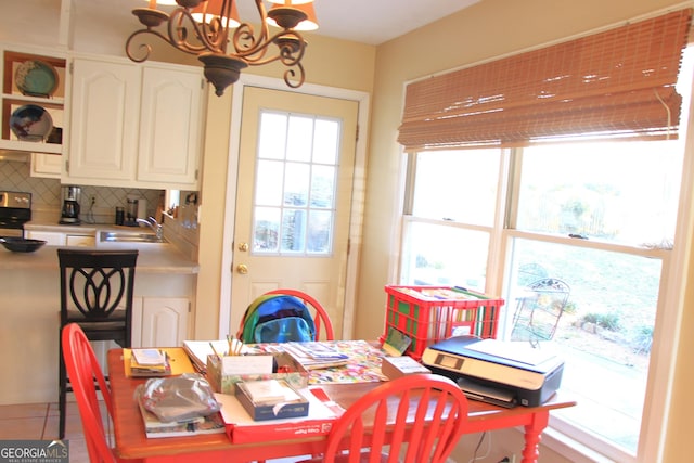 dining room featuring an inviting chandelier and tile patterned flooring