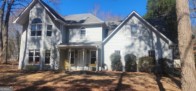 rear view of property with a porch