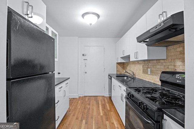 kitchen featuring black appliances, dark countertops, exhaust hood, and white cabinets