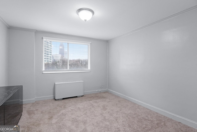 unfurnished room featuring baseboards, crown molding, and light colored carpet