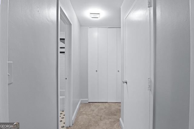 hallway with light colored carpet