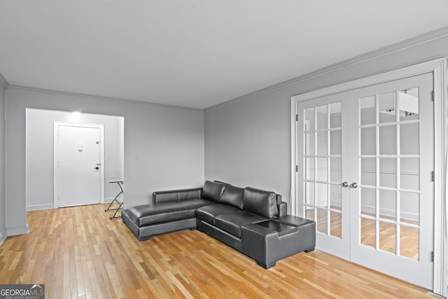living room with crown molding, wood finished floors, and french doors