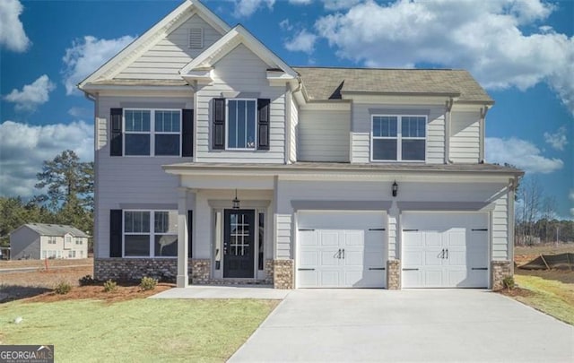 view of front facade featuring an attached garage, a front lawn, and concrete driveway