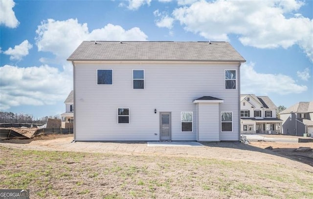 rear view of property featuring a patio area and a yard