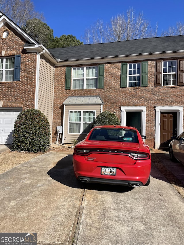 townhome / multi-family property featuring brick siding