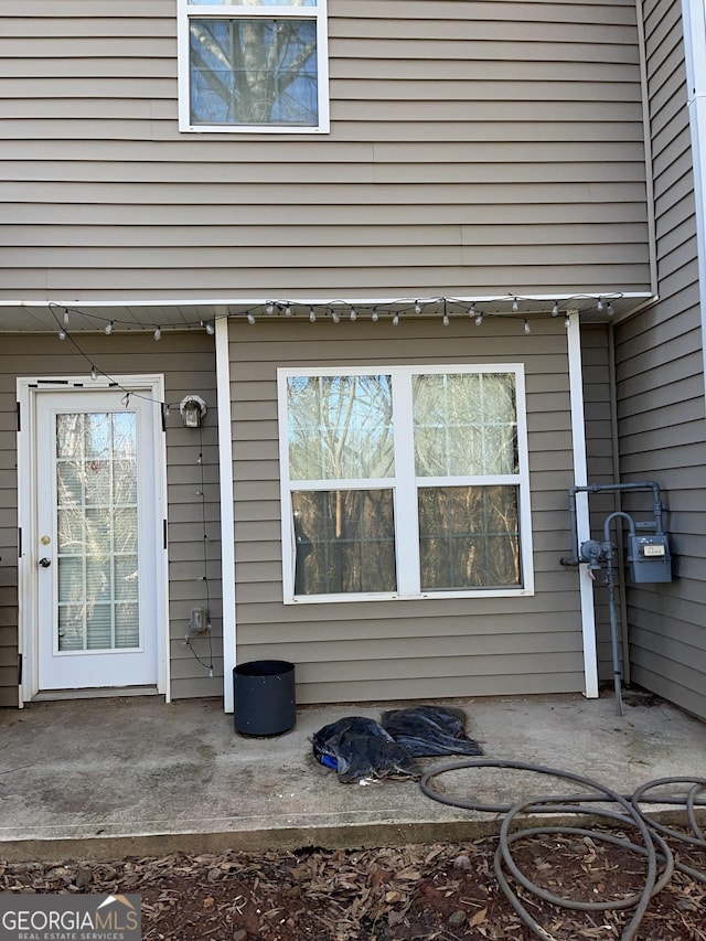 view of exterior entry featuring a patio