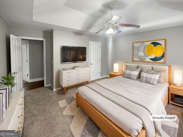 carpeted bedroom with a ceiling fan and baseboards