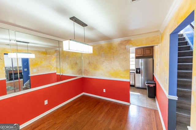 interior space with ornamental molding, dark wood-type flooring, baseboards, and stairs