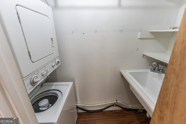 laundry room with stacked washer / dryer and a sink