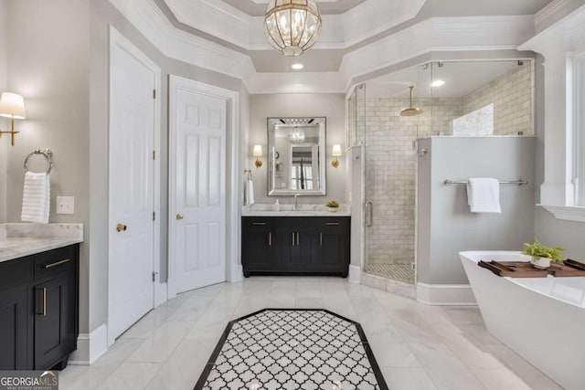 full bath featuring a freestanding tub, vanity, baseboards, ornamental molding, and a stall shower