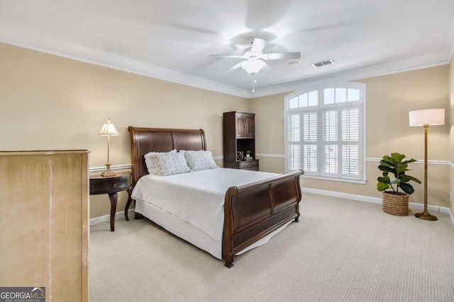 bedroom featuring visible vents, baseboards, crown molding, and light colored carpet