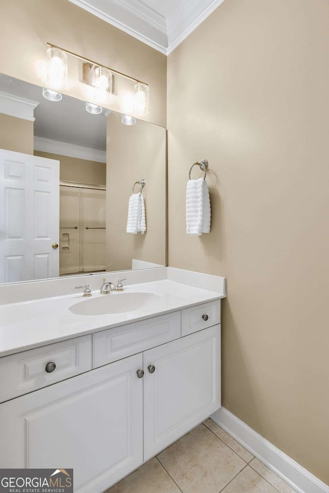 bathroom with vanity, baseboards, crown molding, and tile patterned floors