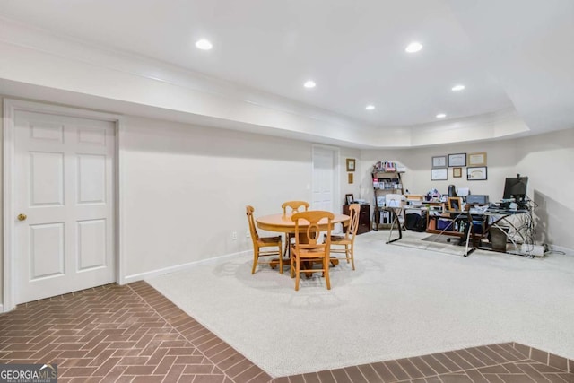 dining room featuring baseboards, a raised ceiling, and recessed lighting