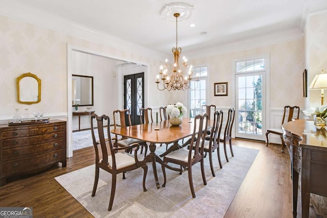 dining room featuring ornamental molding, french doors, a wainscoted wall, and dark wood-style flooring