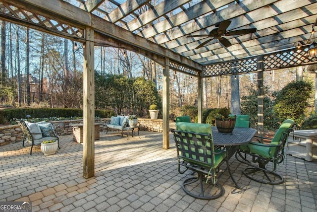 view of patio featuring outdoor dining space, outdoor lounge area, ceiling fan, and a pergola