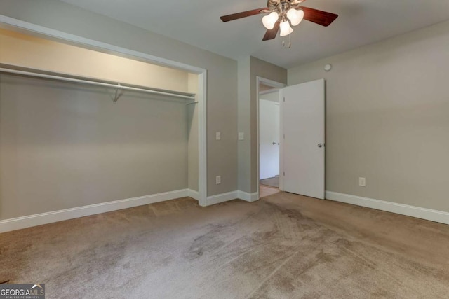 unfurnished bedroom with light colored carpet, ceiling fan, and baseboards