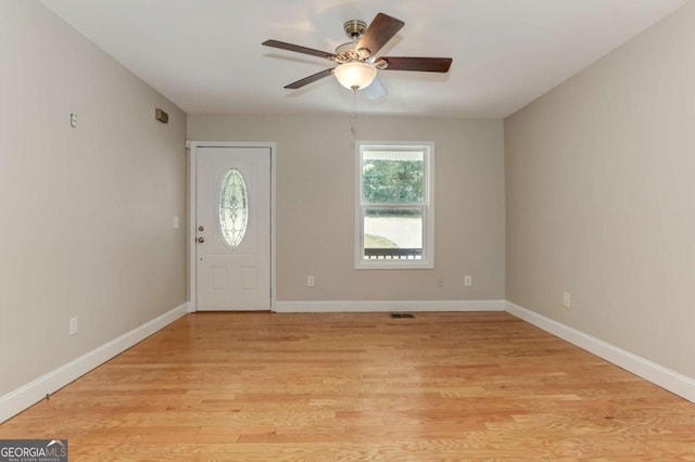 foyer entrance featuring light wood-type flooring, baseboards, and a ceiling fan