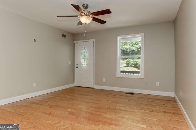 entryway with light wood-style floors, visible vents, baseboards, and a ceiling fan