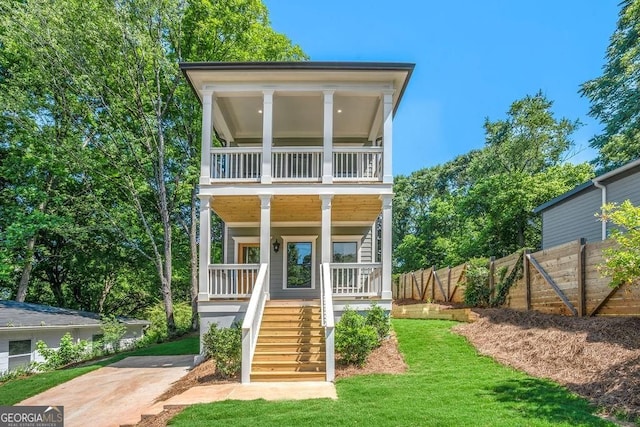 view of front of house featuring stairs, fence, and a porch