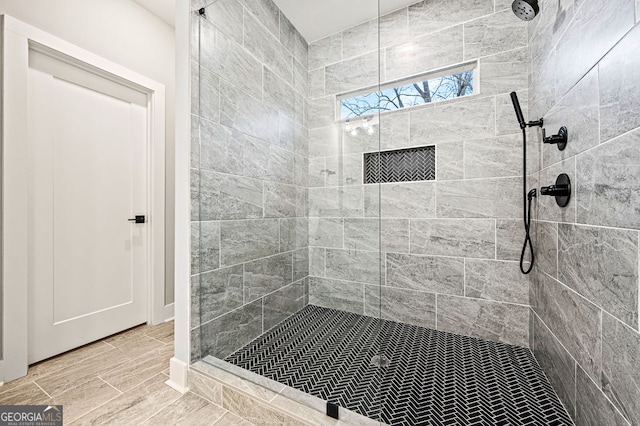 full bath with a tile shower