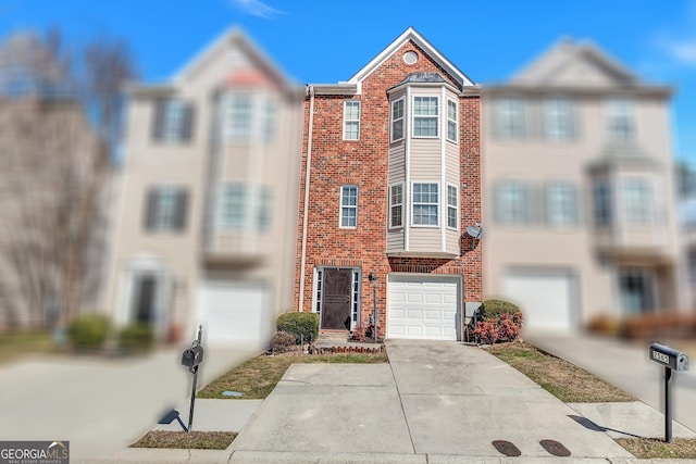 multi unit property featuring a garage, concrete driveway, and brick siding