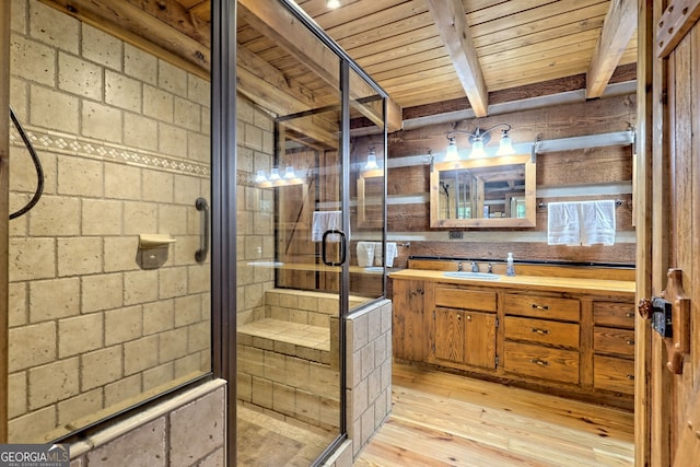 bathroom featuring vanity, beam ceiling, a shower stall, and hardwood / wood-style flooring