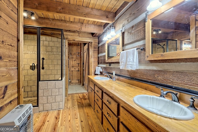 bathroom with wood ceiling, wood finished floors, a sink, and a shower stall