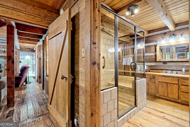 ensuite bathroom featuring wooden ceiling, a shower stall, and wood-type flooring