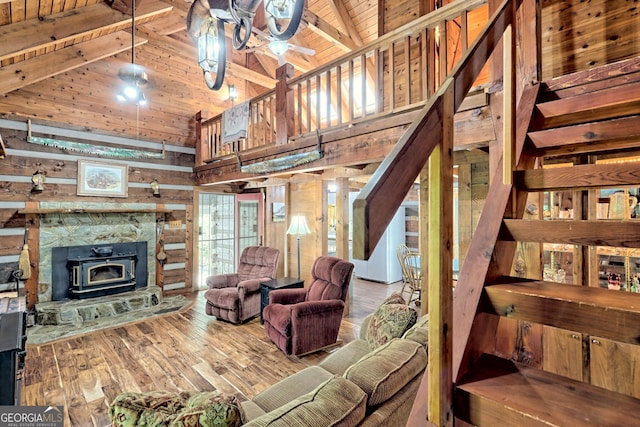 living area featuring wood ceiling, wooden walls, wood finished floors, and beamed ceiling