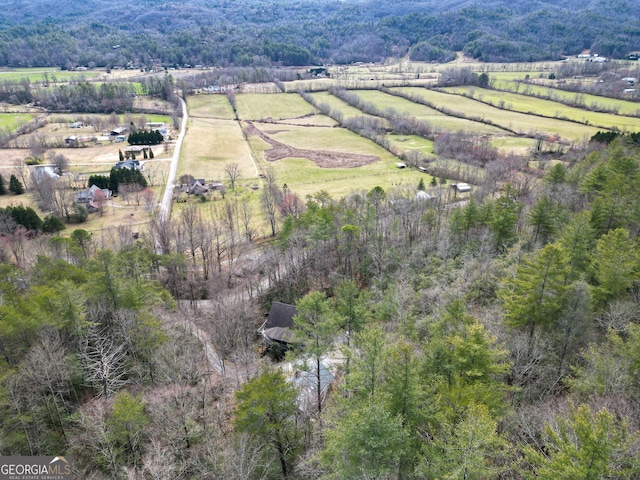 drone / aerial view featuring a forest view and a rural view