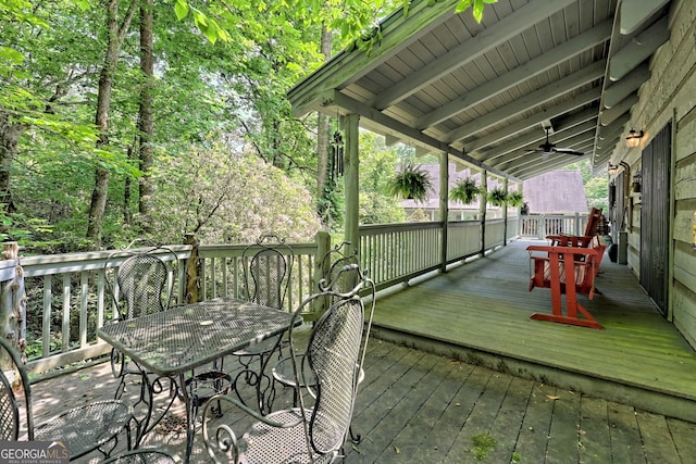 deck featuring a ceiling fan and outdoor dining space