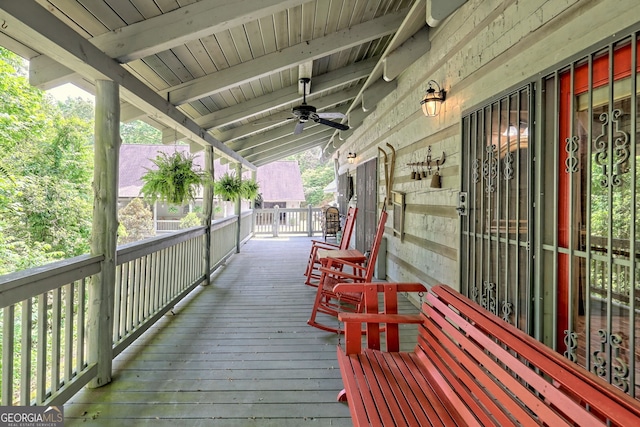 wooden deck featuring a ceiling fan and a porch