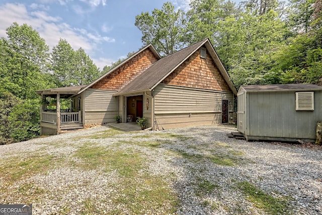 rustic home with a shed and an outbuilding