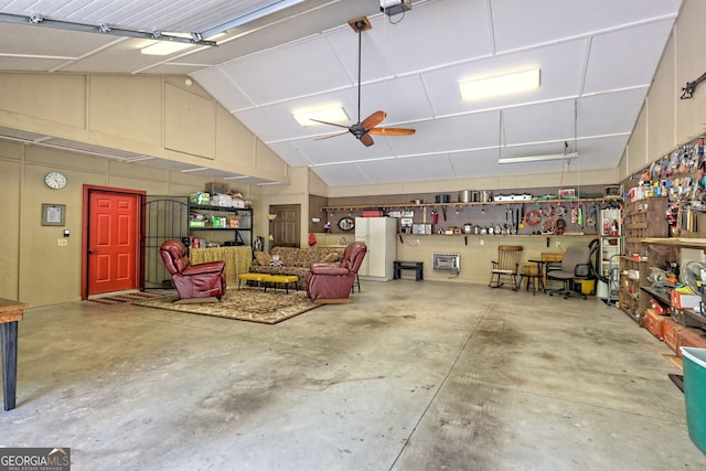 garage with a ceiling fan and white fridge with ice dispenser