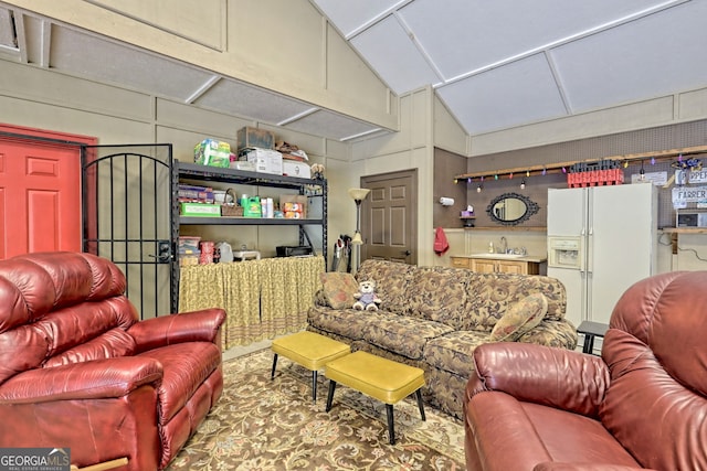 living room featuring vaulted ceiling and a decorative wall