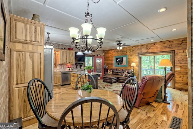 dining area with wooden walls, visible vents, ceiling fan, light wood-type flooring, and recessed lighting