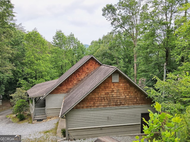 view of home's exterior featuring roof with shingles