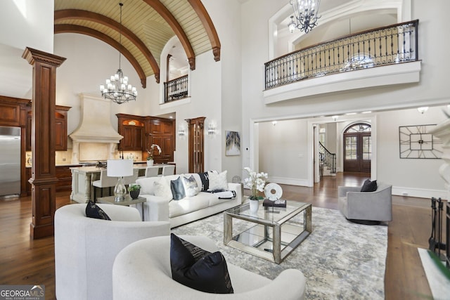 440 Belada Blvd, Sandy Springs, GA 30342 - living room with a chandelier, ornate columns, dark wood finished floors, and high vaulted ceiling