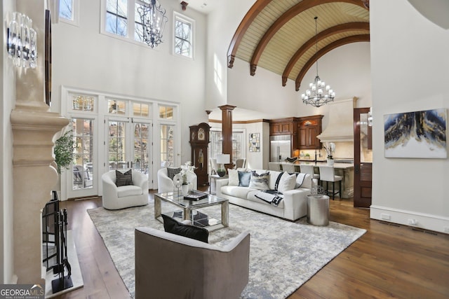 440 Belada Blvd, Sandy Springs, GA 30342 - living room featuring dark wood-style floors, a chandelier, high vaulted ceiling, decorative columns, and wood ceiling