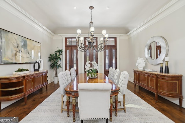 dining space with ornamental molding, dark wood-style flooring, a notable chandelier, and baseboards