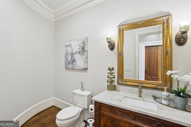 bathroom with baseboards, crown molding, vanity, and toilet