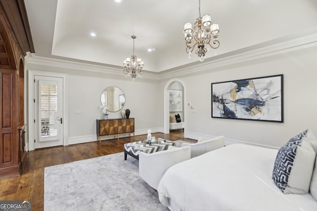 bedroom featuring arched walkways, a notable chandelier, a raised ceiling, dark wood-type flooring, and baseboards