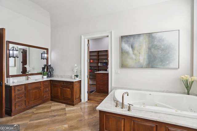 bathroom with a whirlpool tub and vanity