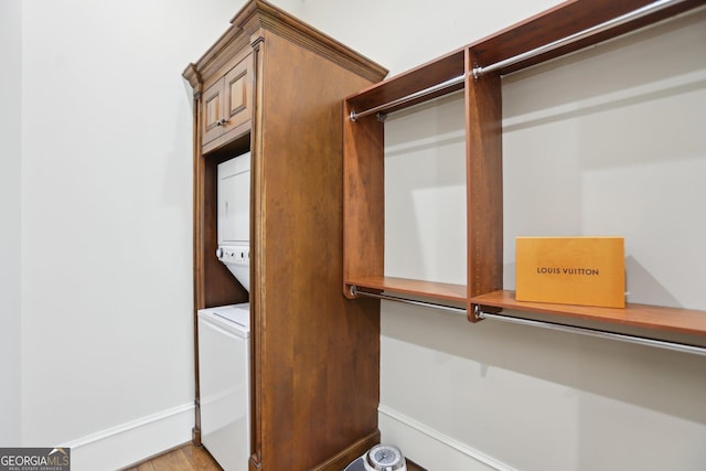 walk in closet featuring stacked washer and clothes dryer