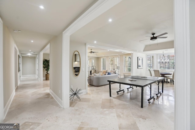 game room featuring ceiling fan with notable chandelier, baseboards, and recessed lighting