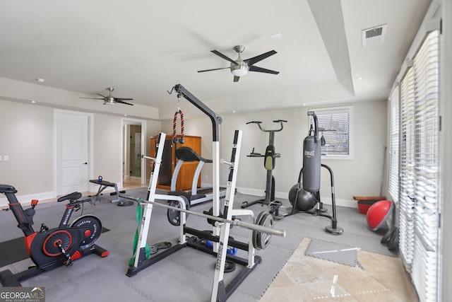 workout area with a ceiling fan, visible vents, and baseboards