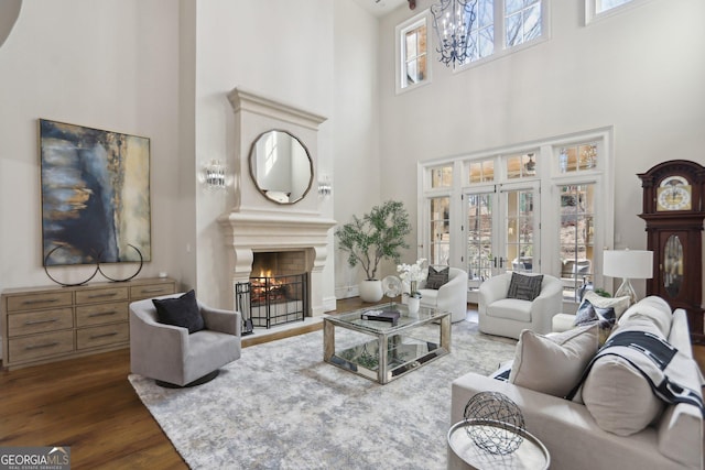 440 Belada Blvd, Sandy Springs, GA 30342 - living room with a high ceiling, a warm lit fireplace, dark wood finished floors, and a chandelier