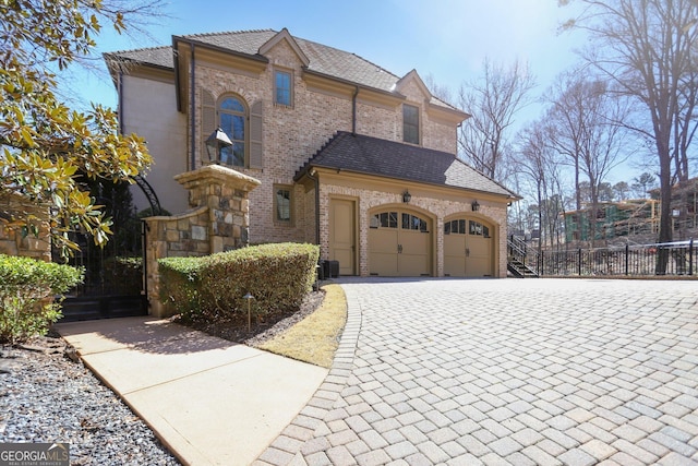440 Belada Blvd, Sandy Springs, GA 30342 - view of front facade with driveway, brick siding, and an attached garage
